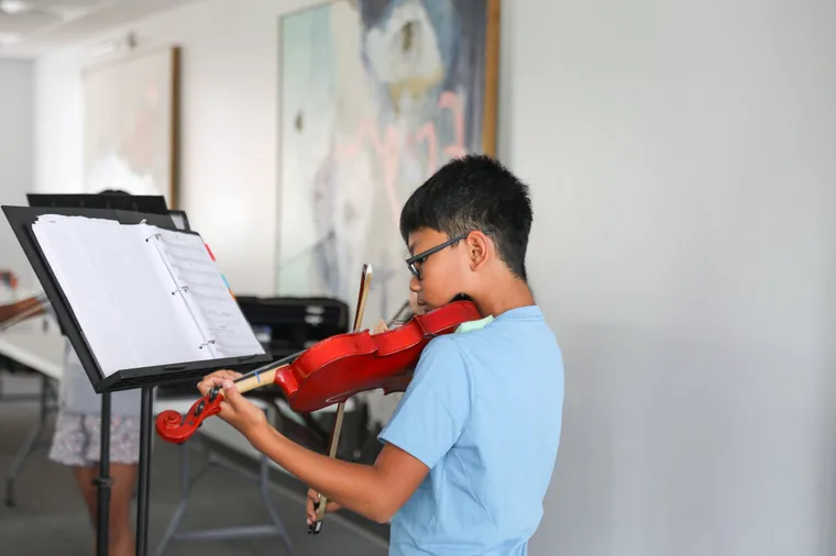 Students of the Raleigh Music Collective playing strings together